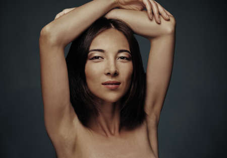 Portrait of beautiful mixed race woman with makeup on dark の写真素材