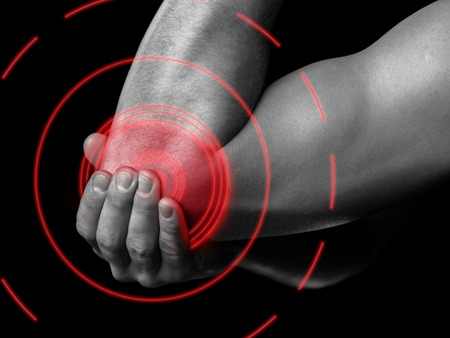 The man is touching the elbow due to acute pain, pain area of red colorの写真素材