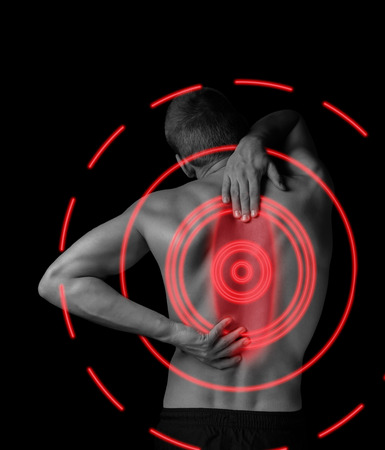 Man is touching the back, concept of pain in the spine, monochrome image, pain area of red colorの写真素材