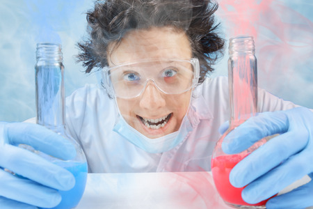 Happy chemist with flask in laboratoryの写真素材