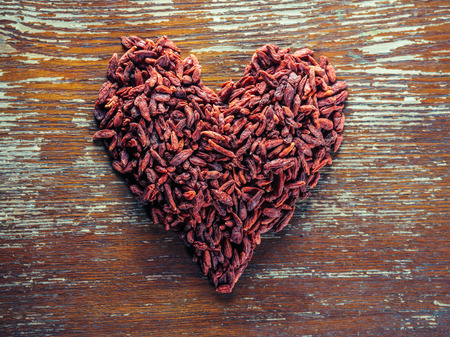 Red dried goji berries in the shape of heartの写真素材