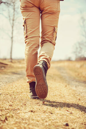 Traveler legs, woman is walking on the path, face is not visibleの写真素材