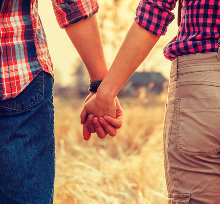Young couple in love holding hands, tranquil scene, face is not visibleの写真素材