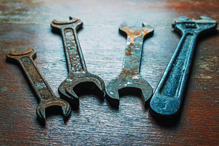 Old rusty wrenches on wooden tableの写真素材
