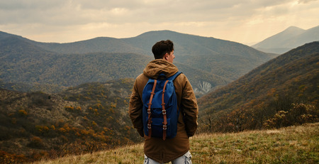 Hiker man with backpack in mountains at autumn seasonの写真素材