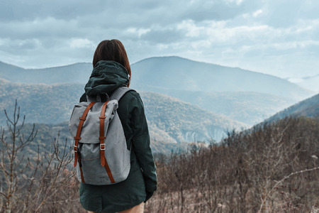 Hiker woman with backpack in mountains at autumn seasonの写真素材