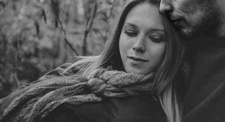 Smiling couple in love rests in park, man embraces a woman. Black and white imageの写真素材