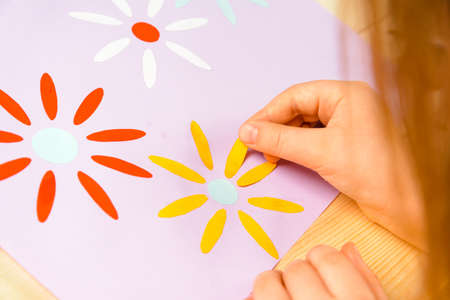 Little girl makes a greeting card for mother on holidayの写真素材