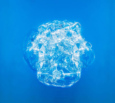 Big bubble in blue water, top viewの写真素材