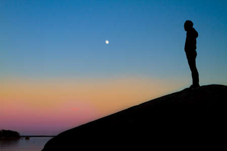 Woman enjoying the silence during a wonderful sunsetの写真素材