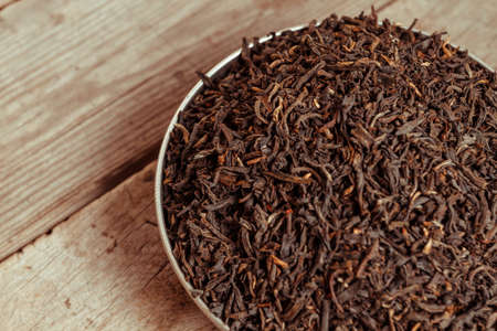 Black leaf tea on a wooden backgroundの写真素材