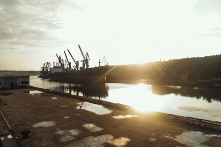 Seaport cargo ship in harbor, image with sunlight effectの写真素材