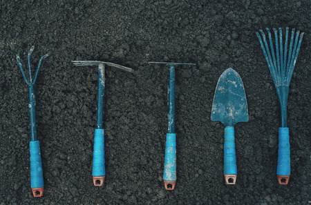 Different gardening tools on soil, top viewの写真素材