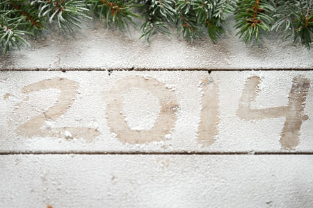 Branches of Christmas tree above the inscription 2014 in the snowの写真素材