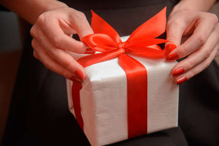 Unrecognizable woman is opening a present, close-up
