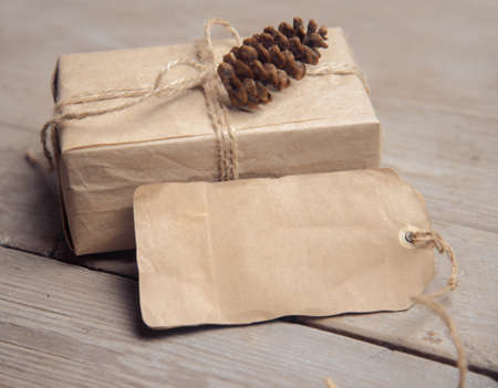 Vintage gift box with a card and cone on a wooden table, copyspaceの写真素材