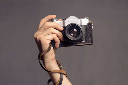 Hand with vintage cameraの写真素材