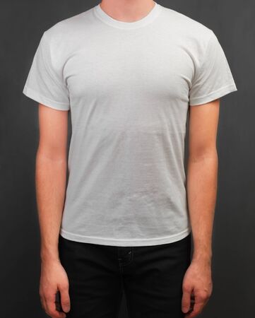 Unrecognizable man stands in the white t-shirt, space for textの写真素材