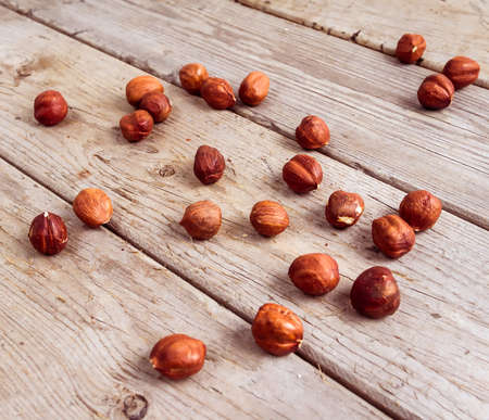 Many nuts scattered on wood texture. Top view