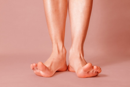 Healthy female feet with splayed fingers on pink の写真素材