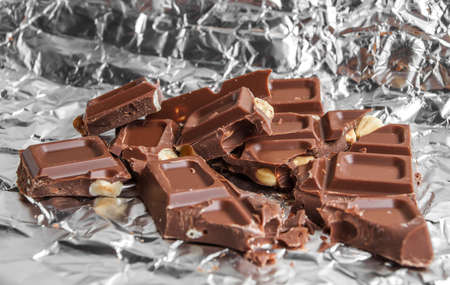 Pieces of chocolate on foilの写真素材