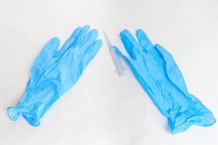 Syringe and blue gloves close-up. の写真素材