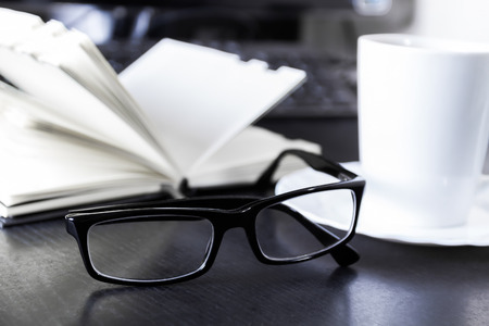 Workplace: glasses and noteの写真素材