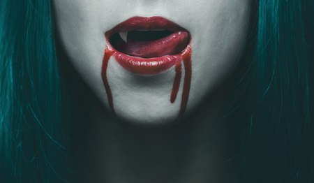 Sensual female vampire lips in blood, close-up image. Halloween or horror themeの写真素材