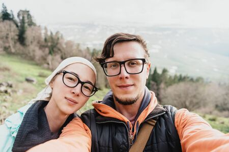 Hiker young loving couple doing selfie in the mountainsの写真素材