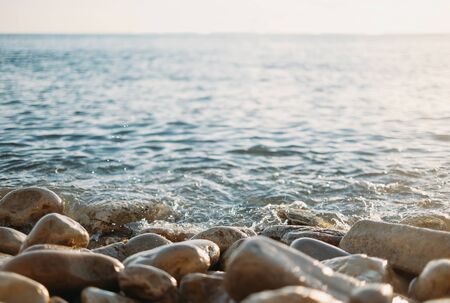 Pebble coast and calm sea.の写真素材