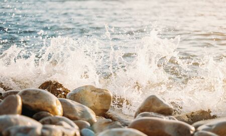 Sea wave on pebble coast, close-up.の写真素材
