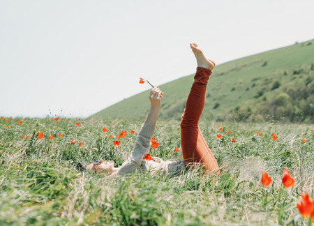 Young woman relaxing on red tulips meadow.の写真素材