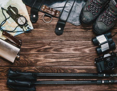 Outfit for tourism and travel on a wooden background, top view. Space for text in center of image.の写真素材