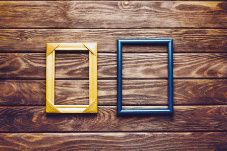 Two empty square frames on a dark wooden background, top view. Copy-space.の写真素材