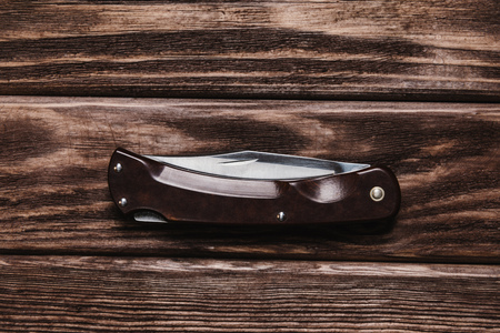 Jackknife on a wooden background, top view.の写真素材