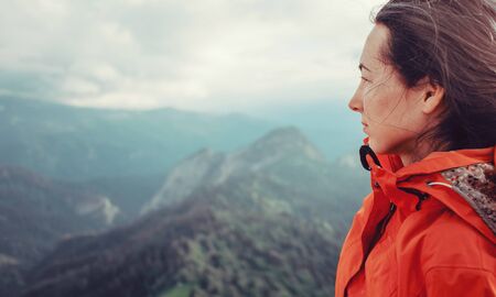 Portrait of hiker young woman on background of summer mountains.の写真素材
