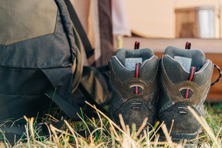Trekking boots near the backpack outdoor.の写真素材