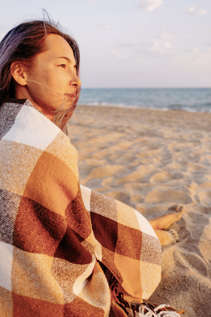 Young woman relaxing on sand beach near the sea, summer vacations.の写真素材