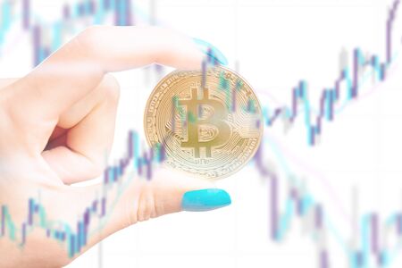 Multiexposure of female hand with symbol of cryptocurrency - bitcoin with diagram.の写真素材