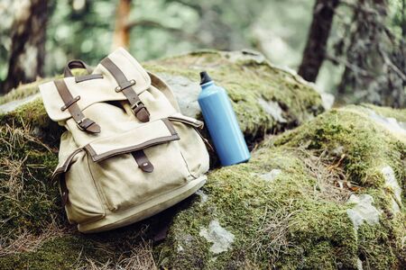 Backpack with water bottle on nature outdoor, hiking equipment.の写真素材