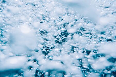 Abstract background of many air bubbles in blue water.