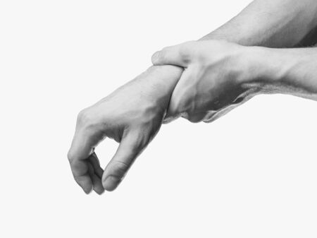 Man holds his hand, acute pain in a wrist. Monochrome image, isolated on a white backgroundの写真素材