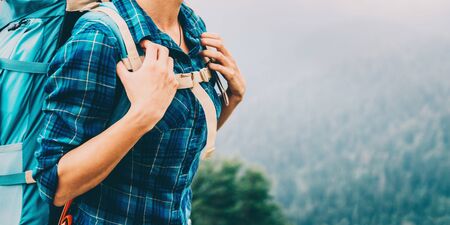 Unrecognizable female hiker with backpack outdoor, close-up imageの写真素材