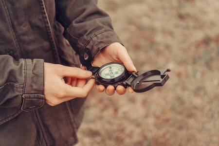 Hiker woman searching direction with a compass outdoor. View of handsの写真素材