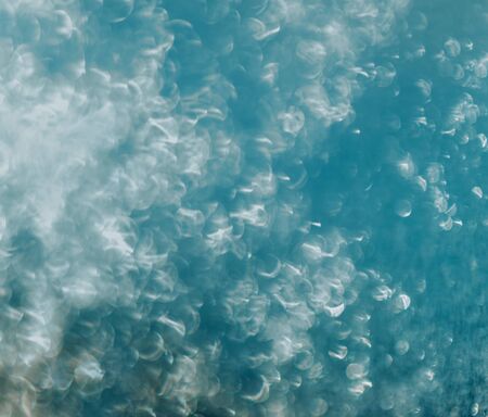 Sunlight glare on glass with water drops, abstract background