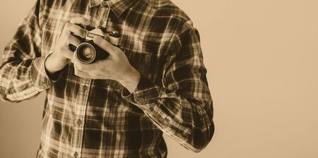 Handsome young man holding old photo camera. Monochrome imageの写真素材