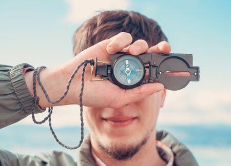 Explorer traveler man with compass outdoorの写真素材