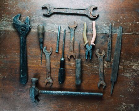 Set of old working tools on wooden surface, top view, no people