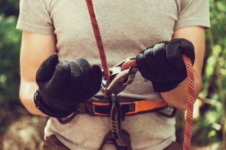GUAMKA, RUSSIA, 03 May 2015: Man ensures the safety of climber man with ropes and device grigri, 03...