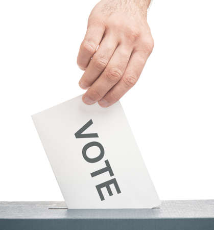 Elections. Male hand putting a ballot with inscription vote into a box on a white background.
